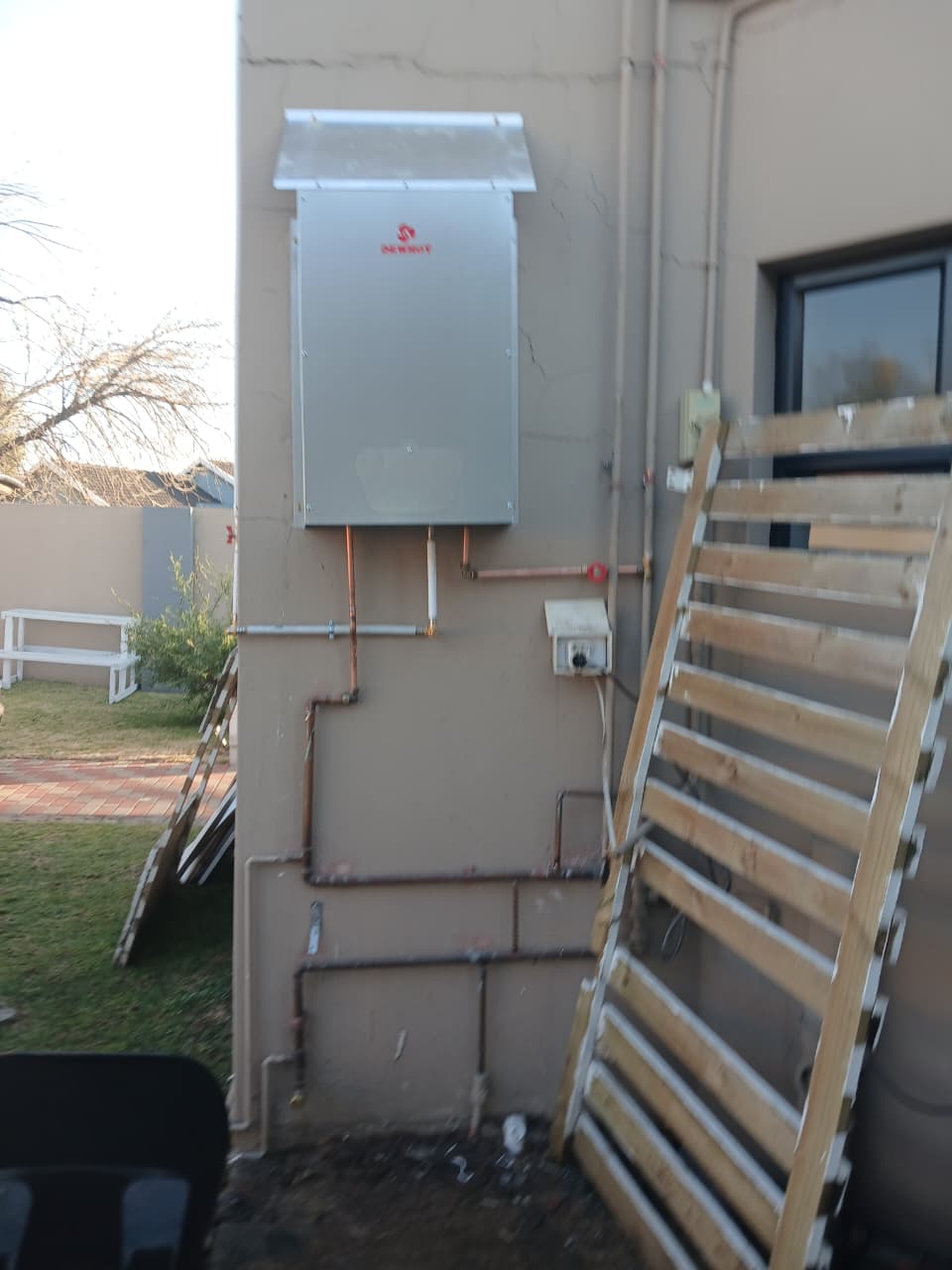 Dewhot outdoor gas geyser water heater installation in Johannesburg